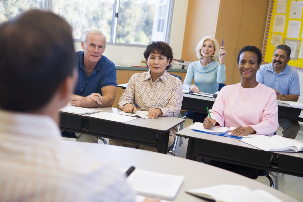 Diverse adult students learning in a classroom